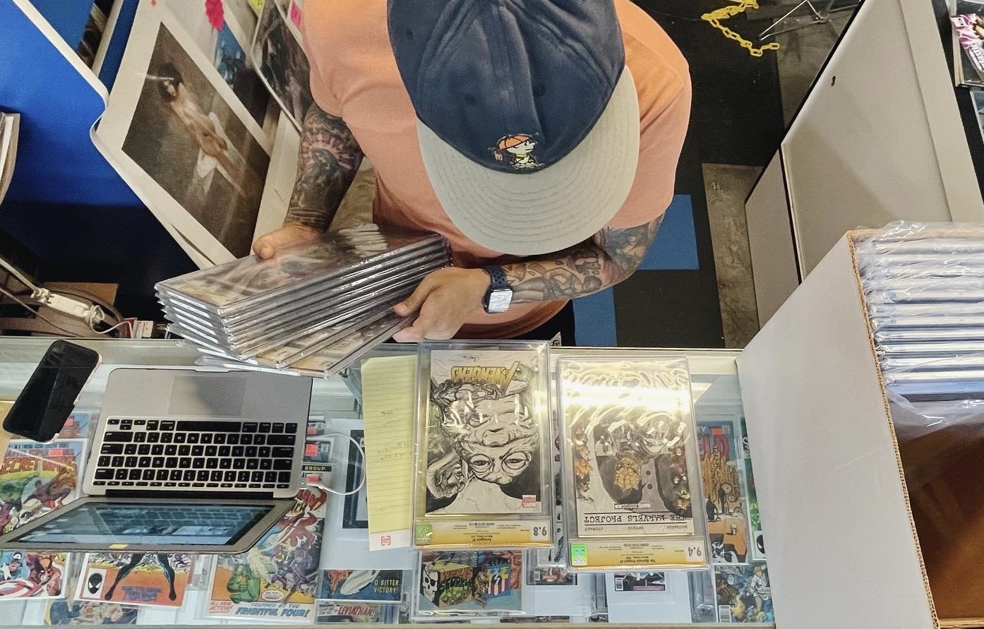Store manager, Matt, going through our recently purchased stack of CGC graded comic books.
